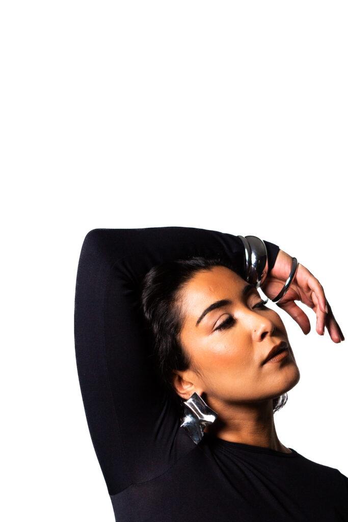 zee la medina wearing all black with a white background